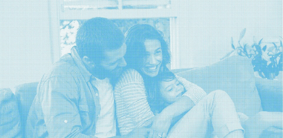 תמונה של משפחה על רקע כחלחל - ילד ישן מחובק בזרועות אימו, האמא מחייכת והאבא מסתכל על הילד